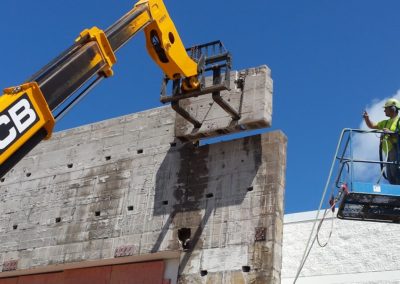 large machine adding concrete wall