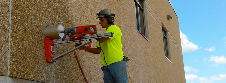 man in hardhat core drilling into wall
